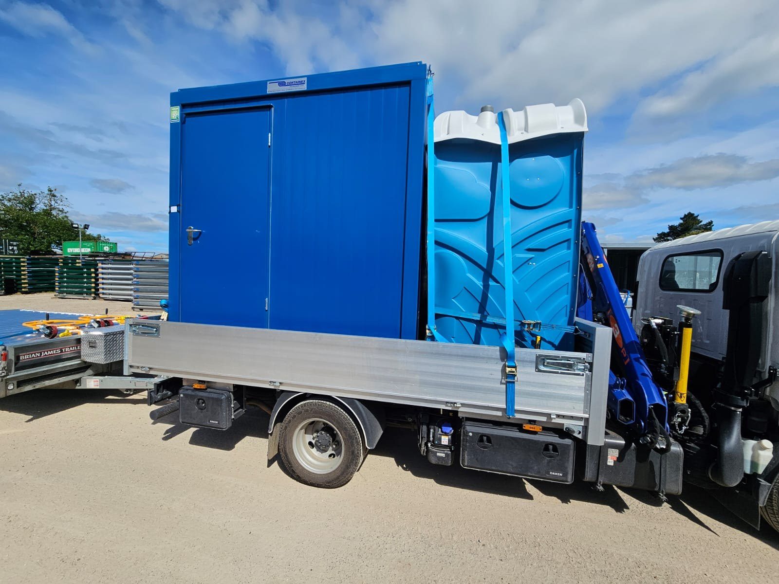 IP&G lorry loaded with a storage container and portaloo