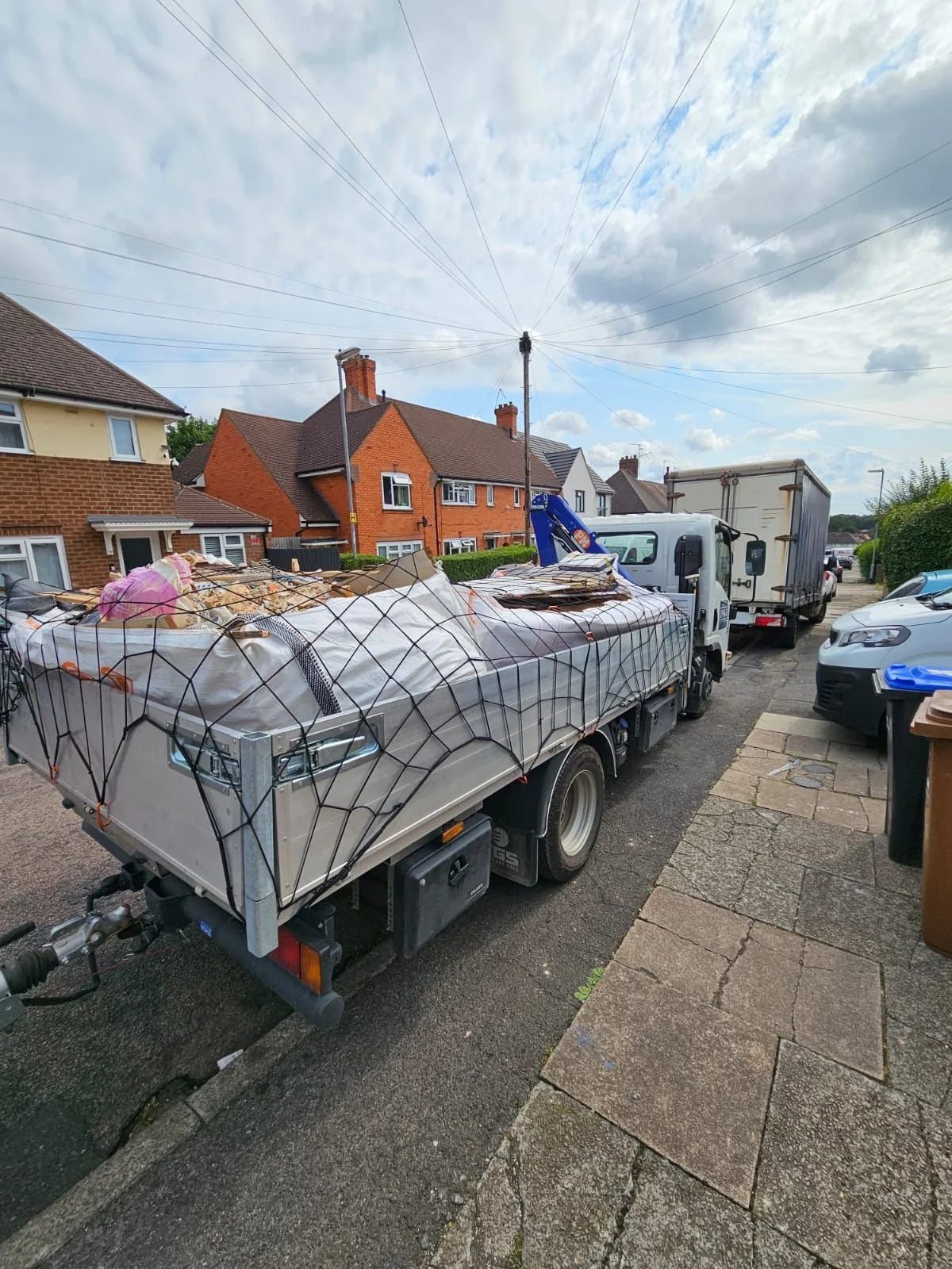 IP&G lorry removing bagged and netted waste from a property